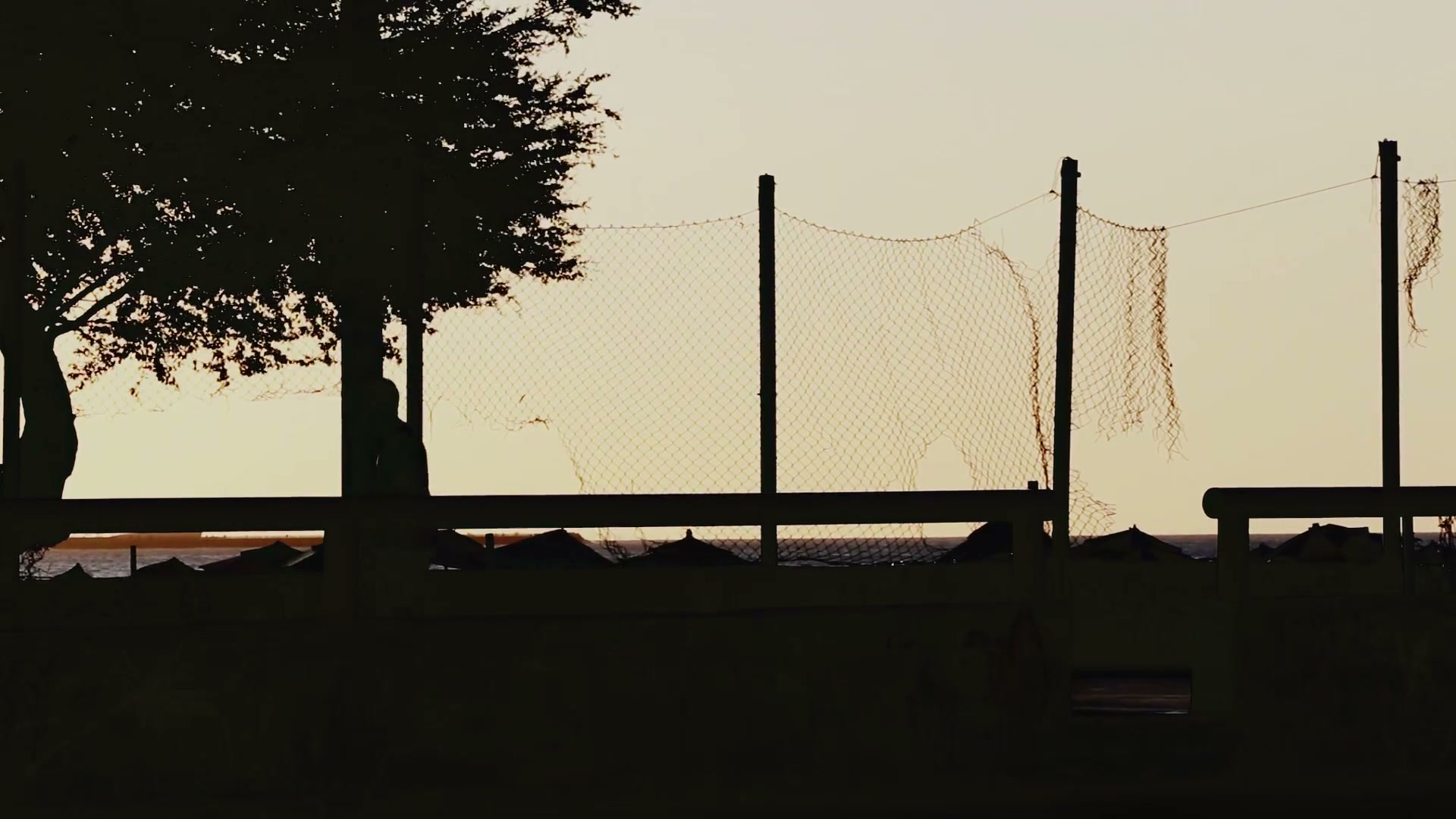 Players silhouetted against the evening sky